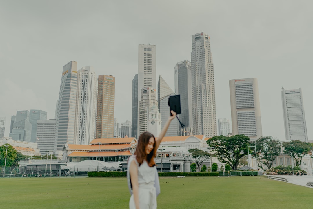 a-woman-in-a-white-dress-holding-up-a-black-object-in-front-of-a-city-frh4omsycre